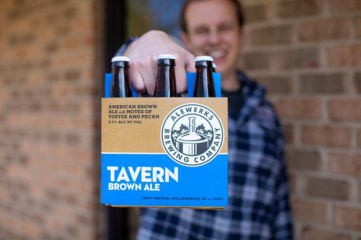 Alewerks Tavern Brown Ale holding six-pack